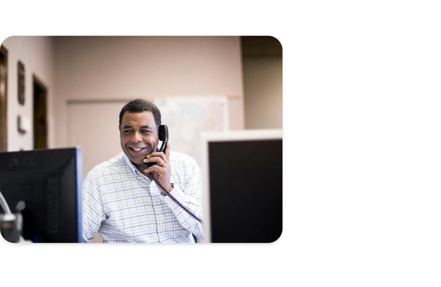 A general contractor on the phone is tracking the success of his company's bids in ConstructConnect Bid Management. 