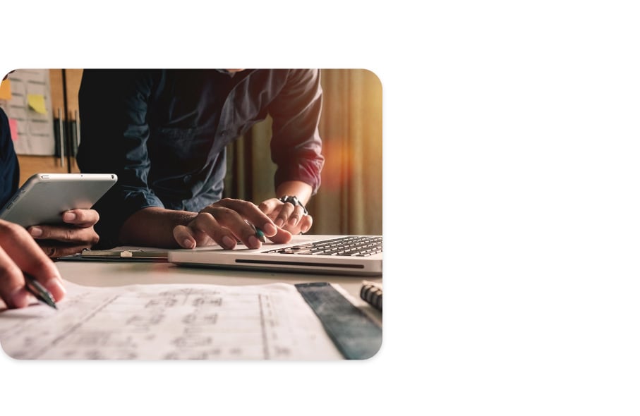 A general contractor uses ConstructConnect Bid Management to track his bids, while a colleague performs a building takeoff.